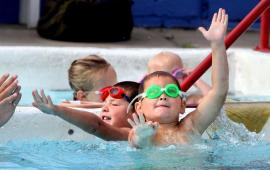 kids swimming in water at pool