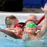 kids swimming in water at pool