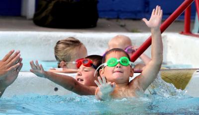 kids swimming in water at pool